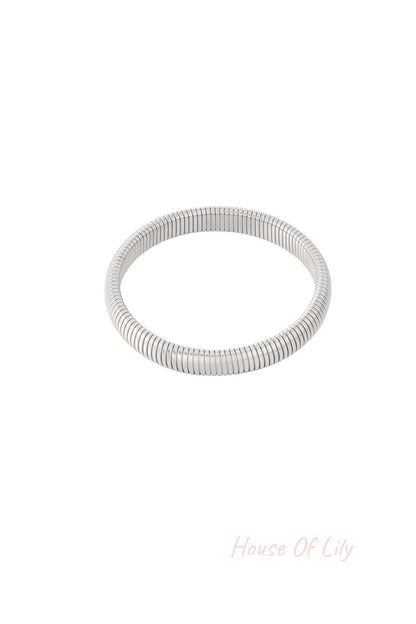 Alternate close-up of the silver stretch bracelet, emphasizing smooth texture and stretch fit on white background