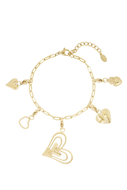 Gold-tone chain charm bracelet featuring various heart-shaped pendants, including a large open-work wire heart.