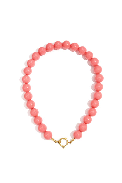 Chunky red resin beaded necklace with gold clasp on white background
