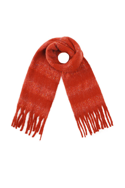 Brick red scarf with fringed ends and bright confetti detail arranged in a loop on a white background
