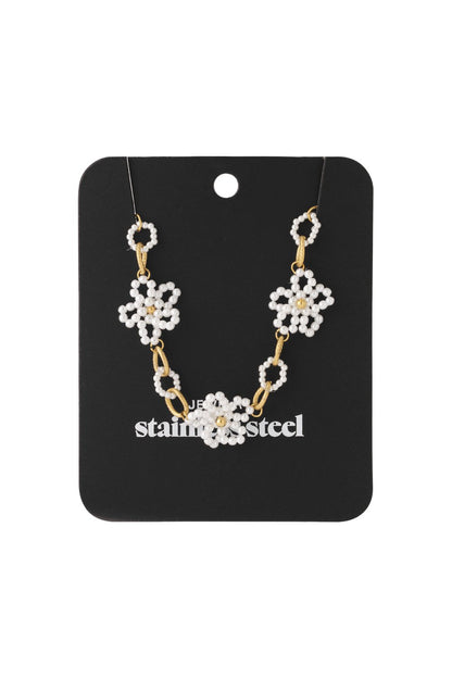 Dainty Bloom Pearl necklace featuring three pearl daisy flowers connected by gold stainless steel oval links.