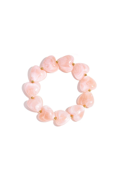 Baby blue marbled heart bead stretch bracelet on white background