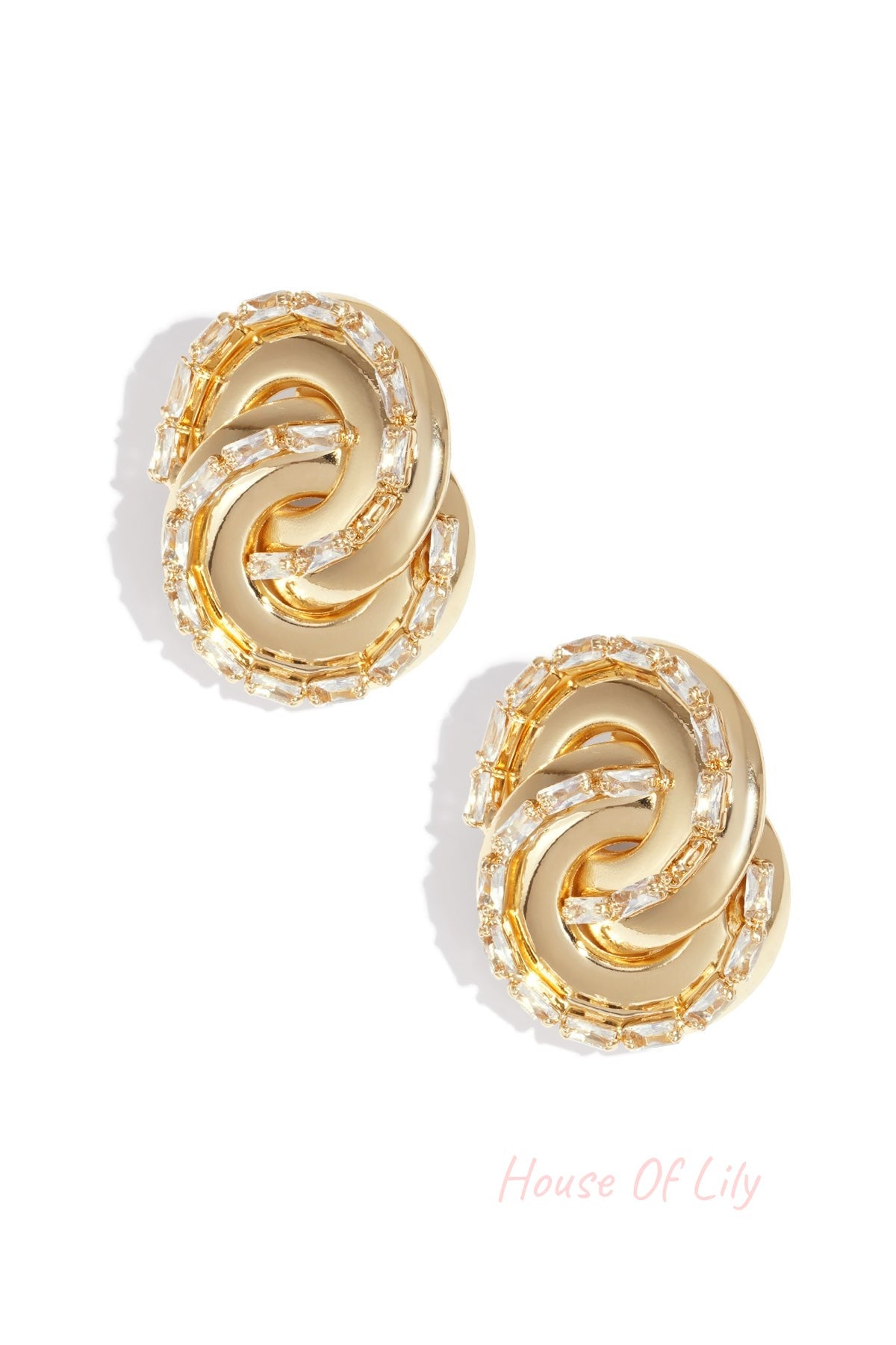 Gold-toned twisted chain stud earrings with baguette-cut crystals on white background