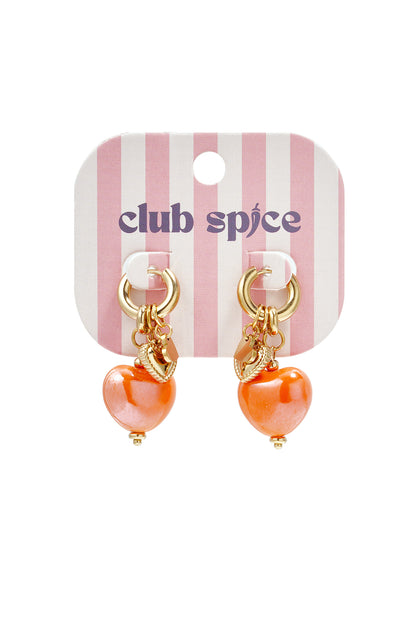 Gold hoop earrings with bright orange heart charms displayed on pink and white striped Club Spice branded card