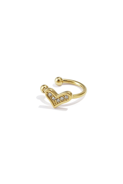 Gold heart-shaped ear cuff studded with rhinestones on white background