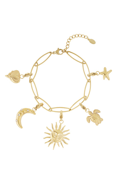 Close-up view of gold charm bracelet showing detailed celestial and sea creature charms on white background