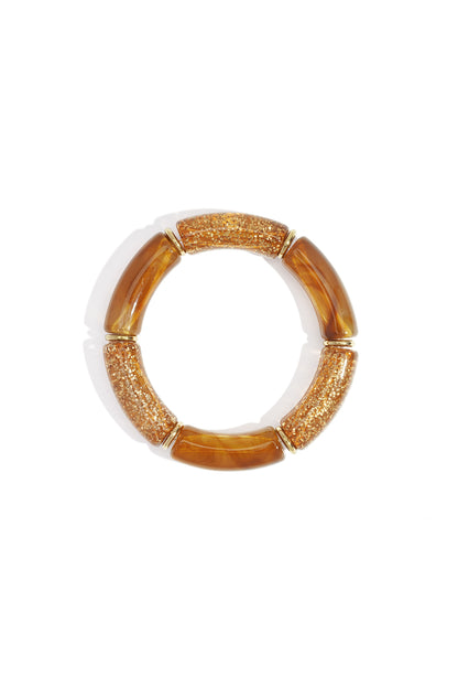 Amber glitter and marbled resin beaded stretch bracelet with gold-tone spacers on white background