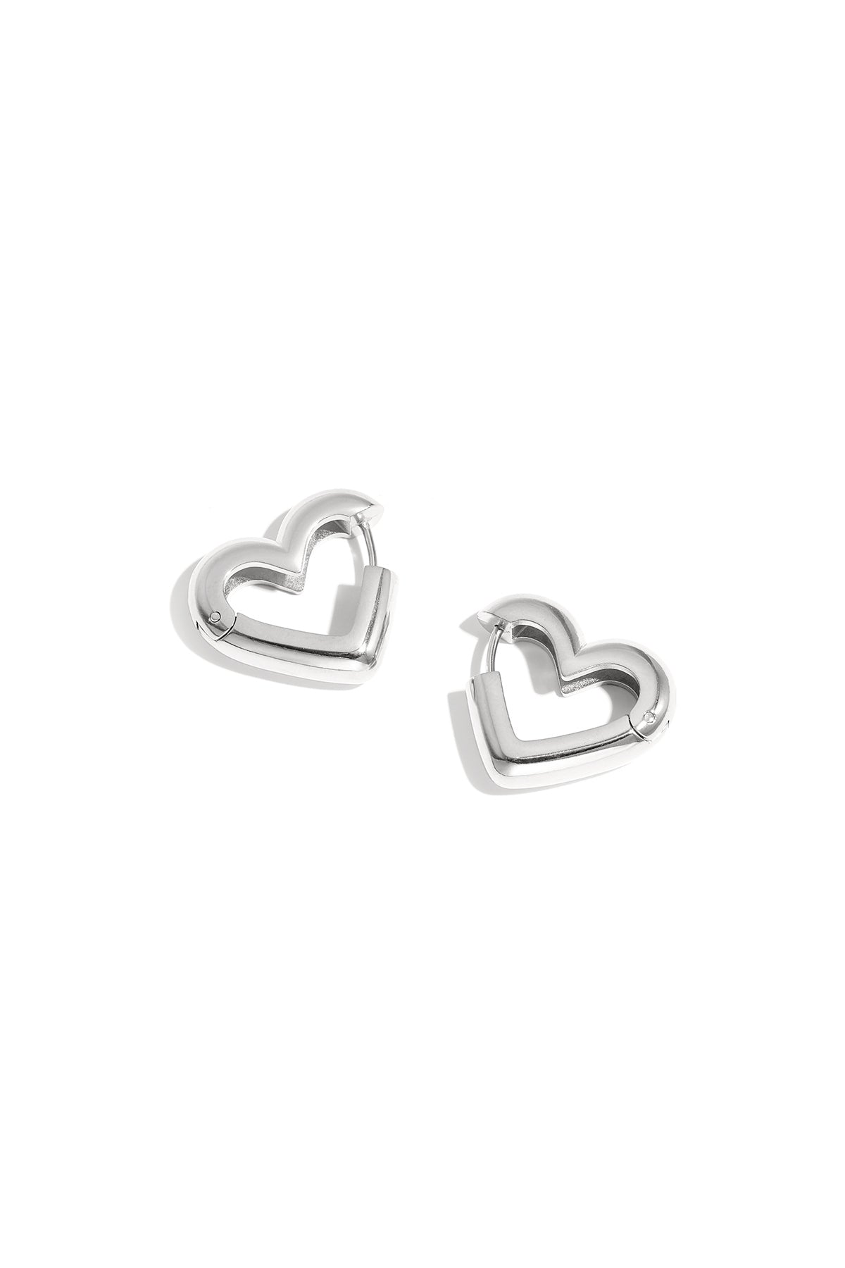 Simple silver heart-shaped hoop earrings shown as pairs on white background