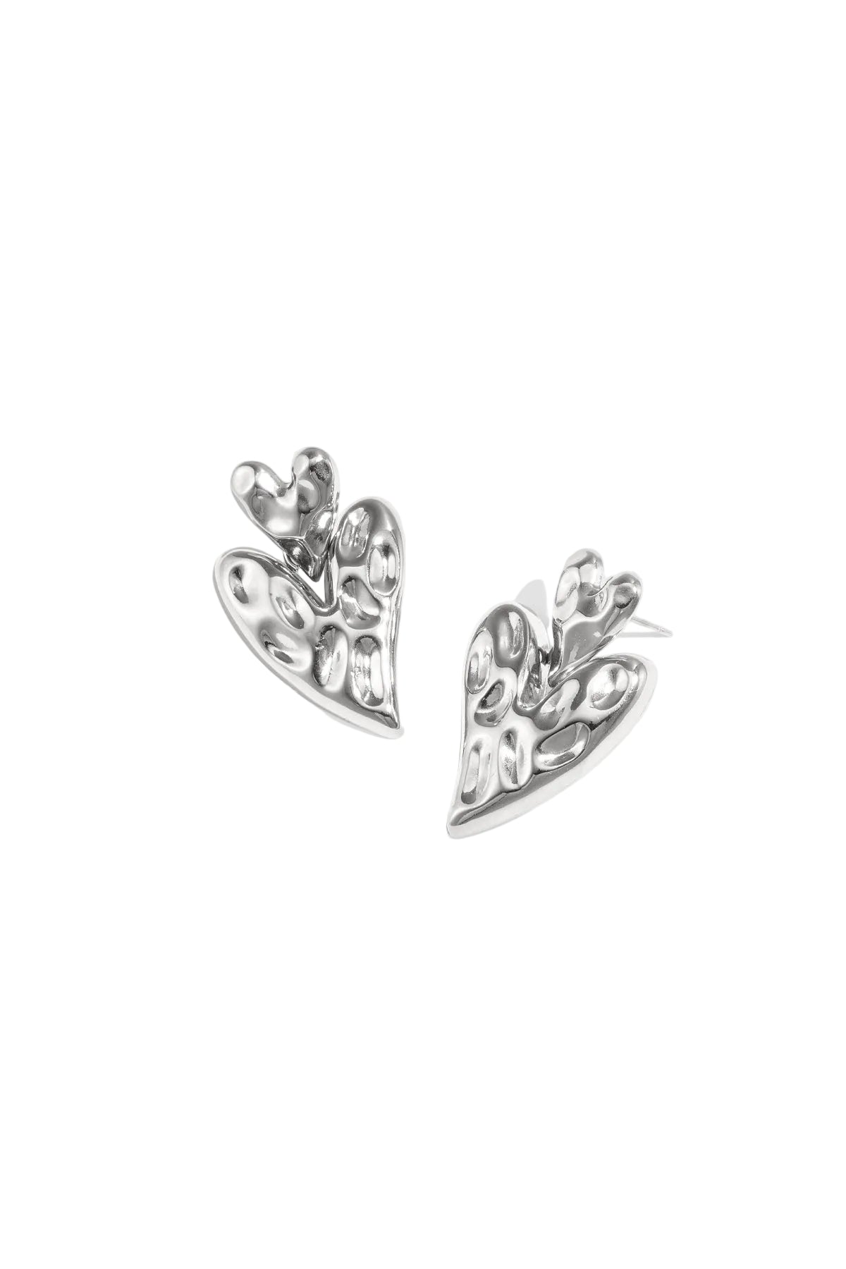Pair of polished silver chunky heart-shaped drop earrings with hammered texture on white background