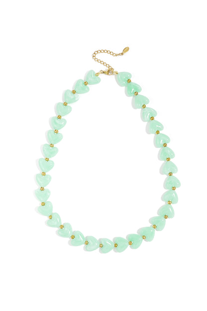 Mint green heart-shaped resin beads accented with small gold spacers on a gold chain necklace.