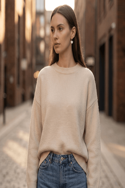 Full-body view of a female model wearing delicate silver radiant heart drop earrings styled for casual outdoor wear with natural light.