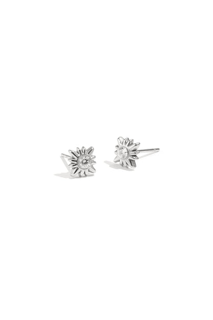 Pair of silver sunburst stud earrings with clear rhinestones on white background
