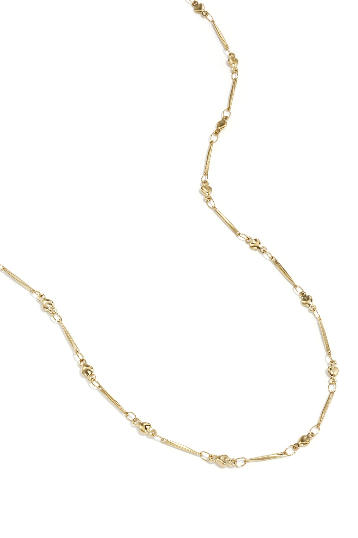 Close-up view of delicate gold necklace with alternating heart-shaped and elongated bar links on white background