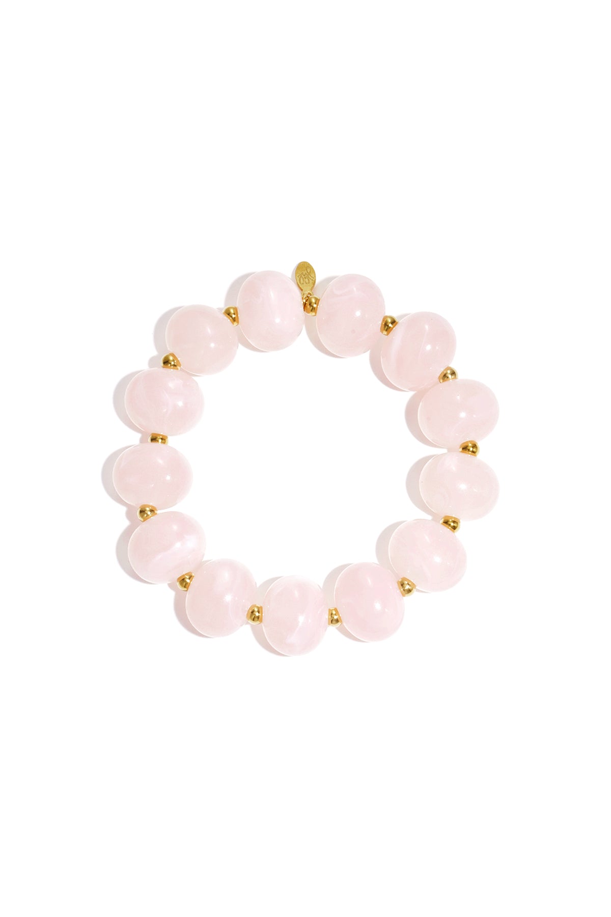 Close up of soft pink marbled beaded stretch bracelet with gold spacer beads on white background