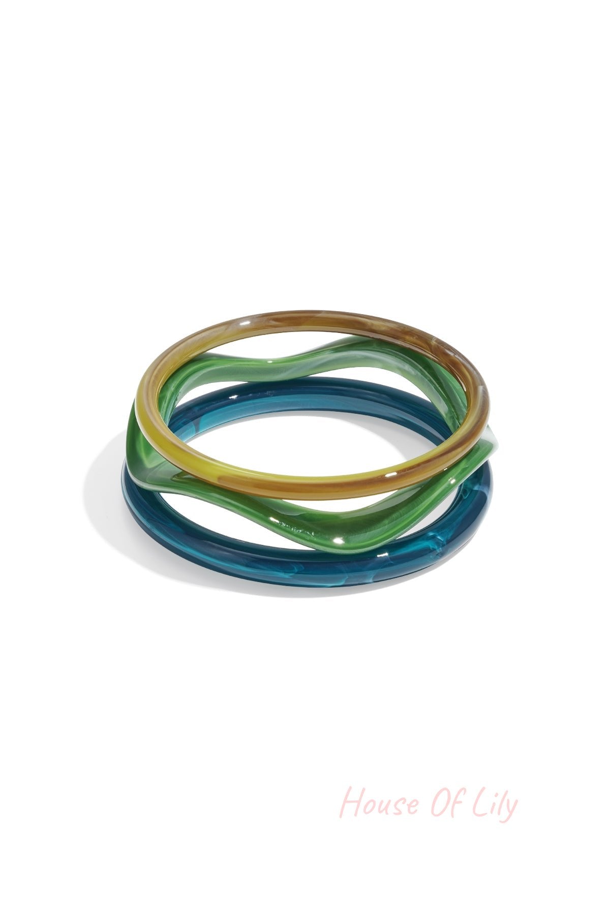 Two acrylic bangles in amber tortoise and red shades stacked on white background