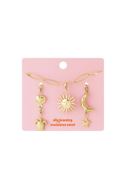 Golden Link Vibe: Gold stainless steel DIY jewelry set with chain, sun, moon, star, heart, and turtle charms on pink.