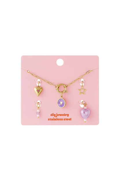 Y2K style gold chain necklace set with purple heart, star, and pearl charms on a pink display card.