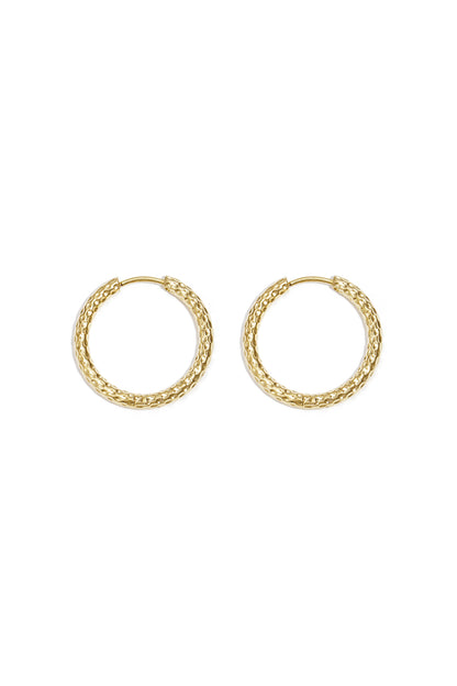 Close-up image of a pair of textured gold hoop earrings laid flat on white background