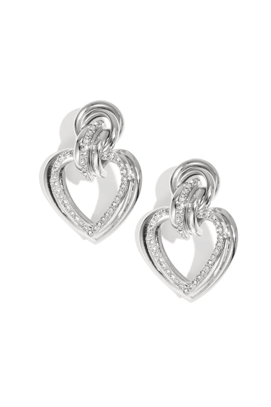 Silver heart-shaped drop earrings with rhinestones on a white background