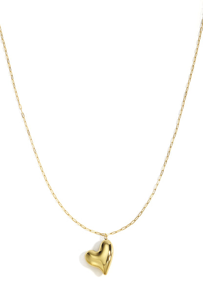 Gold chunky heart pendant necklace with minimal long chain on white background