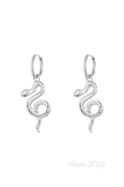 Pair of silver snake charm hoop earrings with rhinestone accents on a white background.