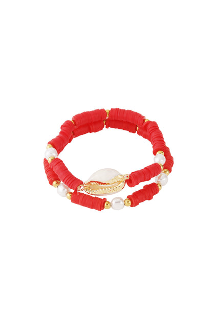 Red shell beaded bracelet set with gold-tone shell centerpiece and pearl accents on white background