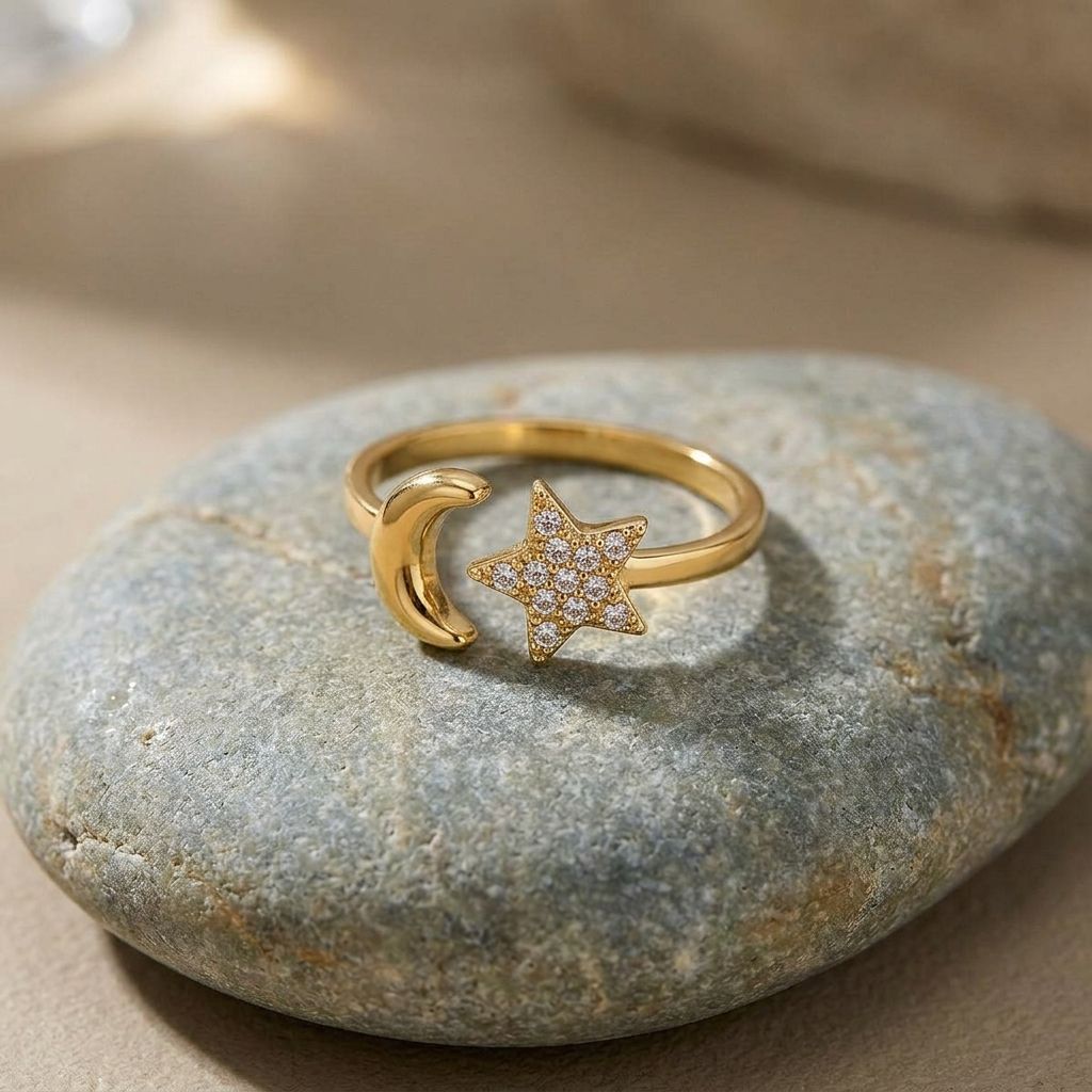 Close-up of the Celestial Magic Ring with moon and star details on a natural stone surface, highlighting its shine and rhinestones.