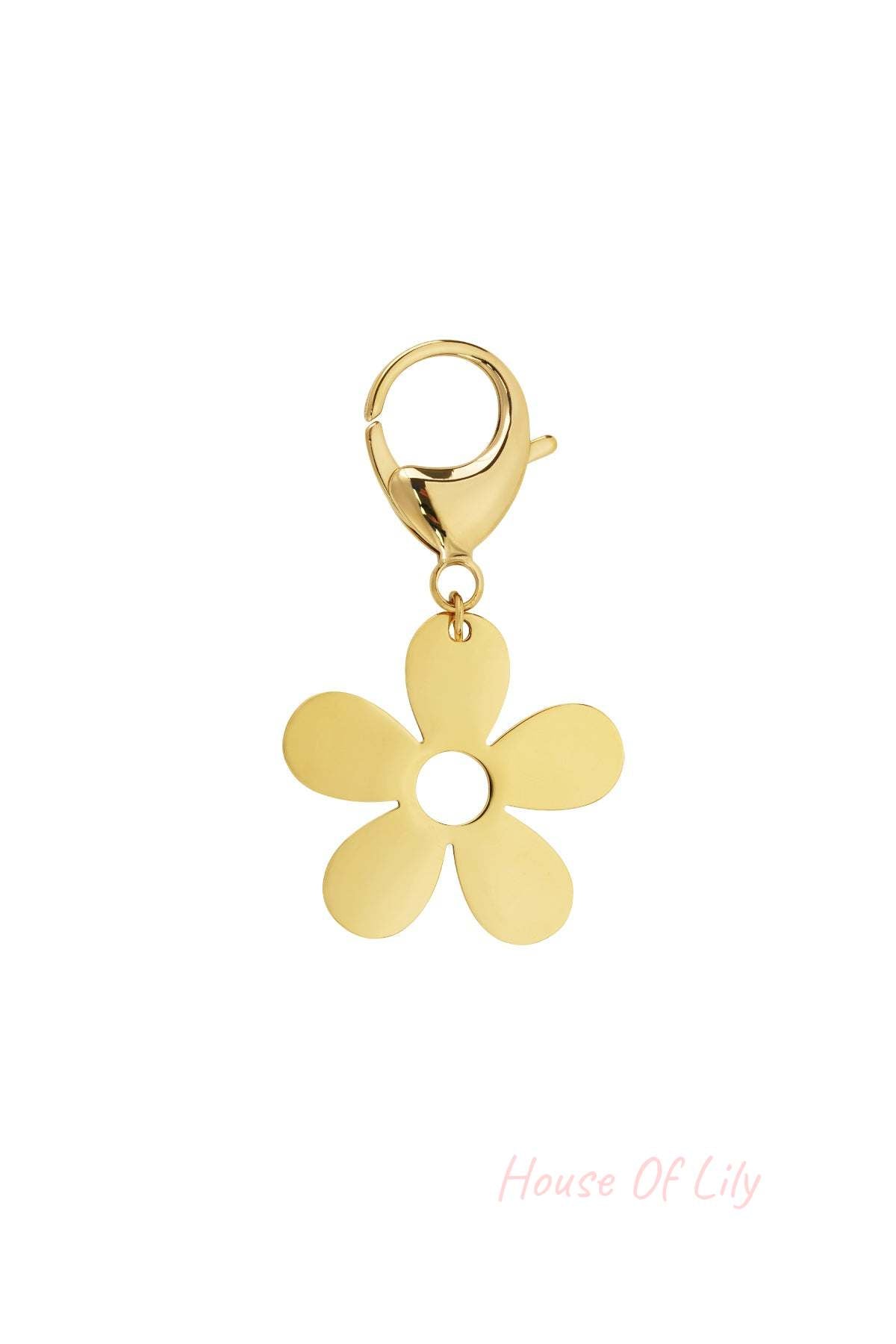 Close-up of a gold flower charm with five petals and a circular center attached to a lobster clasp on white background