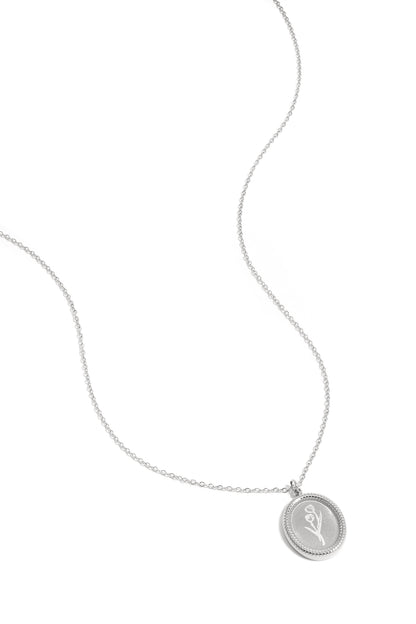 Close-up of silver tulip blossom pendant necklace on white background