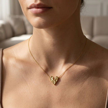 Close-up of the Love Struck Chain necklace on a model’s neckline, showing its silver shimmer and delicate details in natural light.