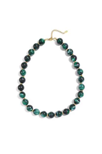 Green marbled chunky beaded necklace with gold spacer beads and adjustable gold chain on white background