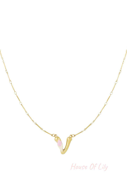 Gold necklace featuring a sculpted "V" initial pendant with white and light pink enamel accents on a slender gold chain.