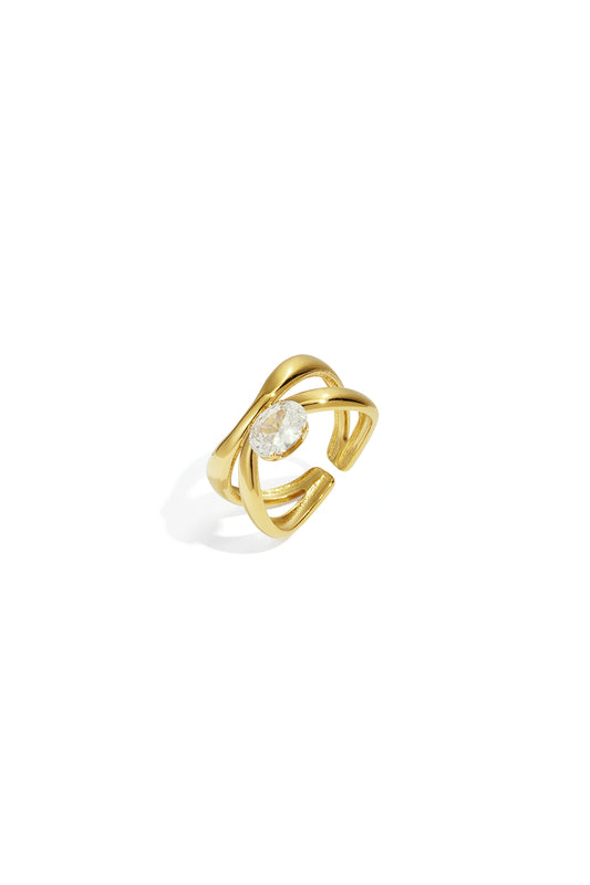 Gold-tone adjustable ring featuring a twisted band with an oval sparkling clear gemstone on a white background