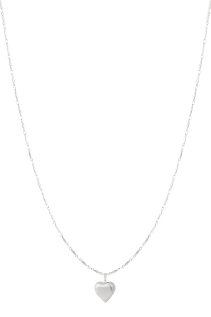 Silver heart-shaped pendant necklace with delicate chain on white background