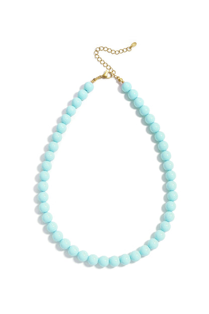 Light blue round resin beaded necklace with a gold-tone chain extender on a white background.