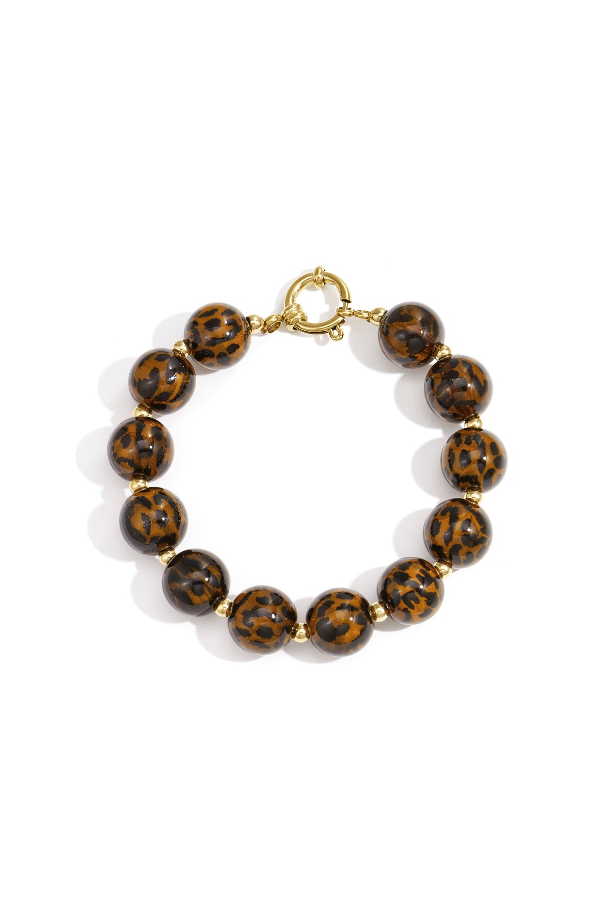 Leopard print beaded bracelet with glossy round acrylic beads and gold-tone spacer beads laid flat on white background