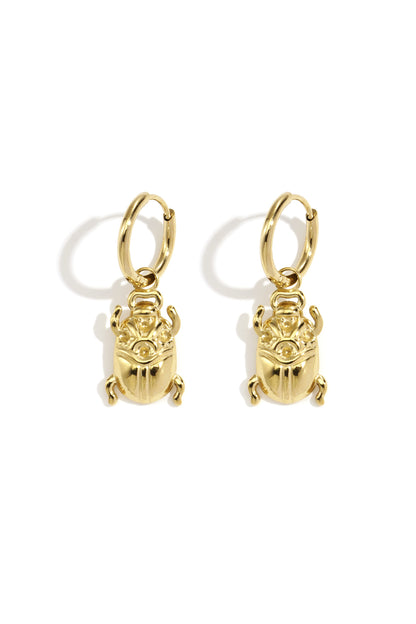 Pair of polished gold bug-shaped drop earrings with hoop fastenings displayed on white background