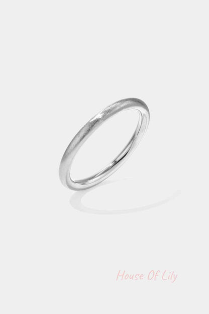 Single matte silver bangle with smooth circular design isolated on white background