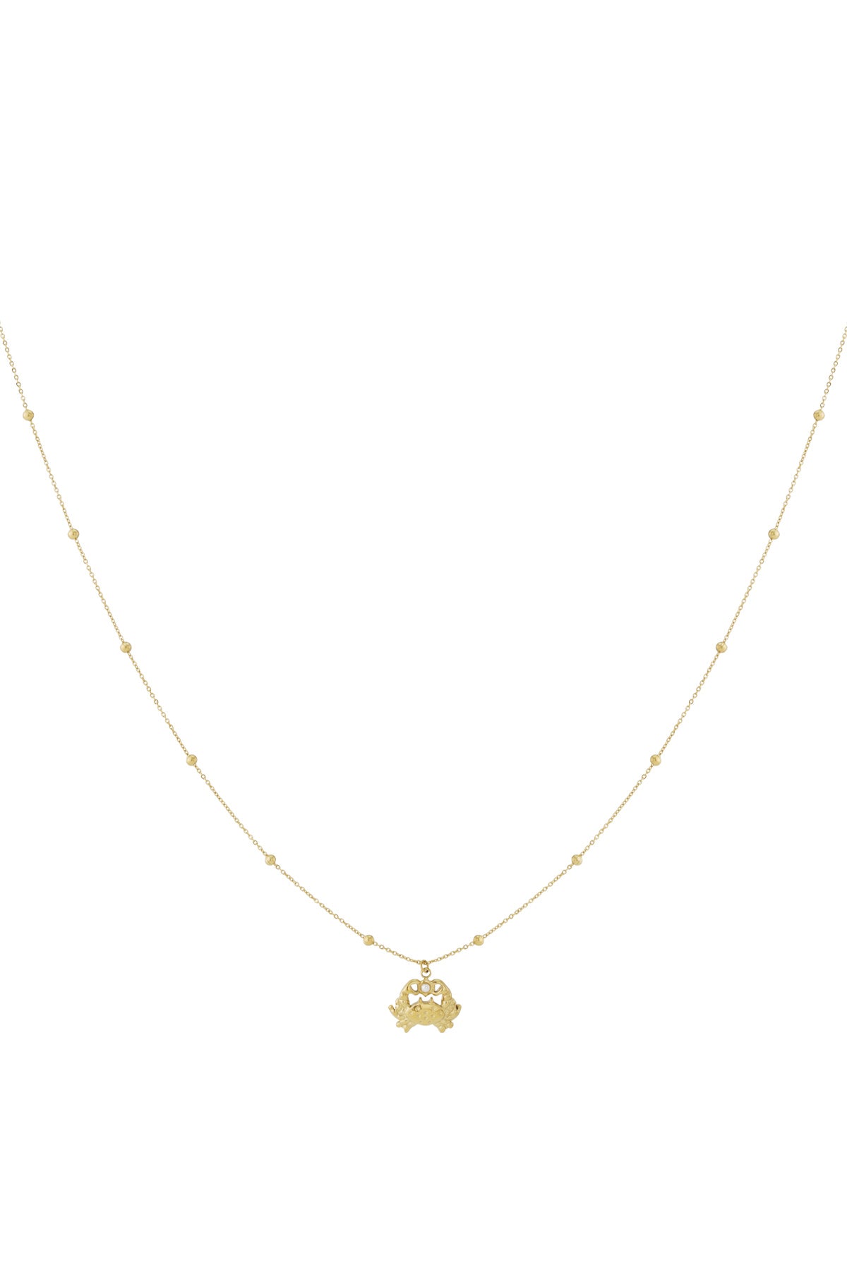 Gold crab charm necklace with fine beaded chain on white background
