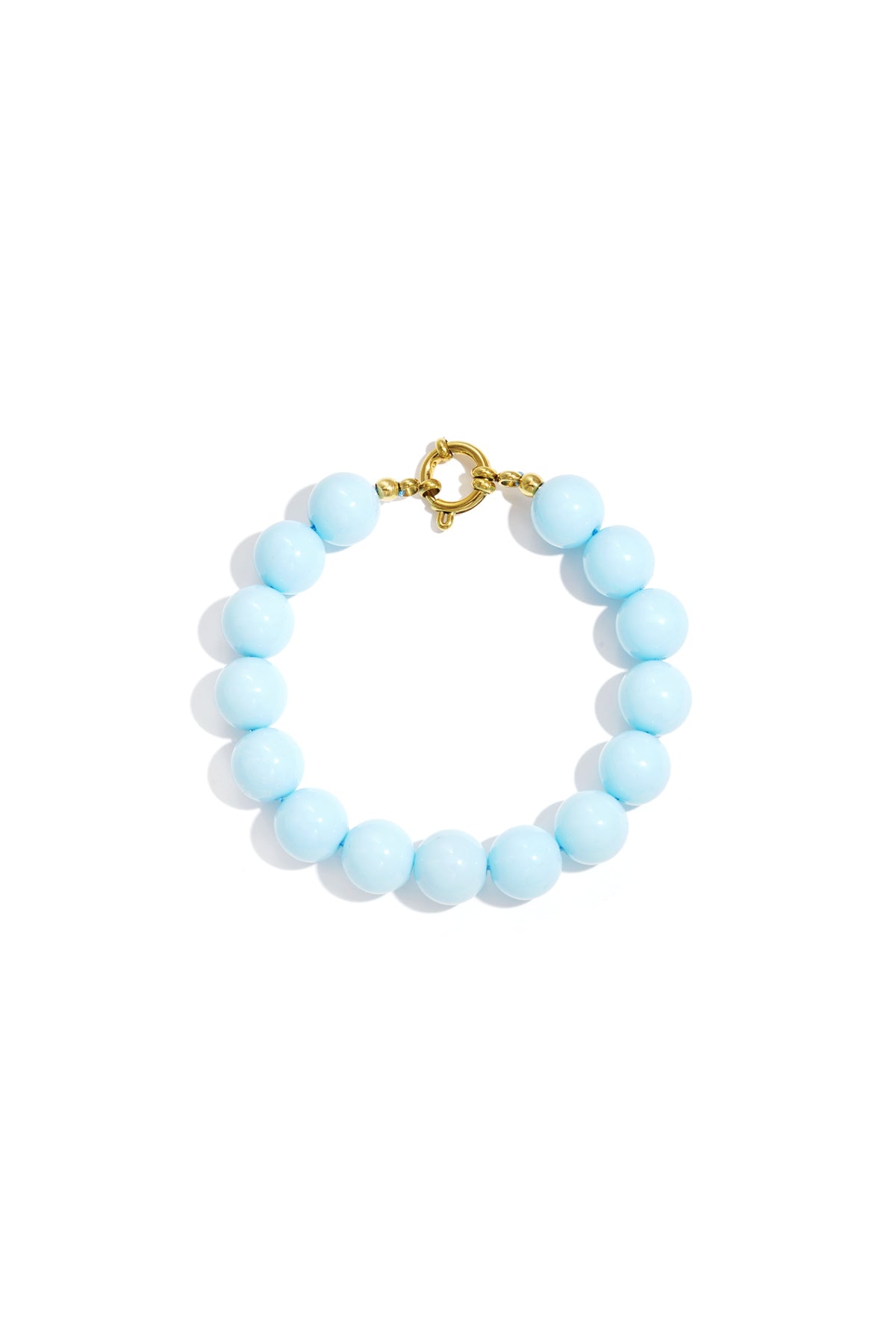 Vibrant light blue round resin beads on a gold-tone spring ring clasp bracelet against a white background.