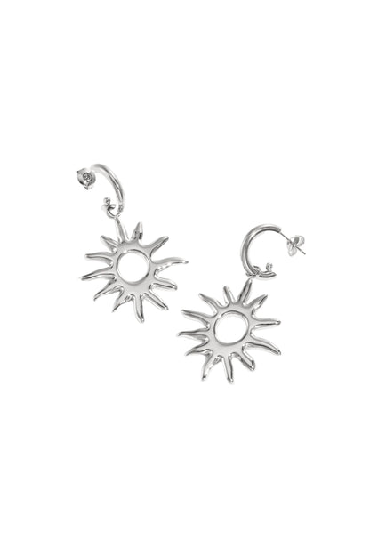 Silver sunburst drop earrings lying flat on white background, showing smooth, radiant design