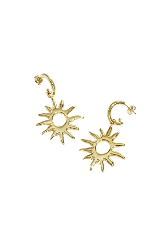 Pair of gold sunburst drop earrings with smooth sun motif and post backings on white background