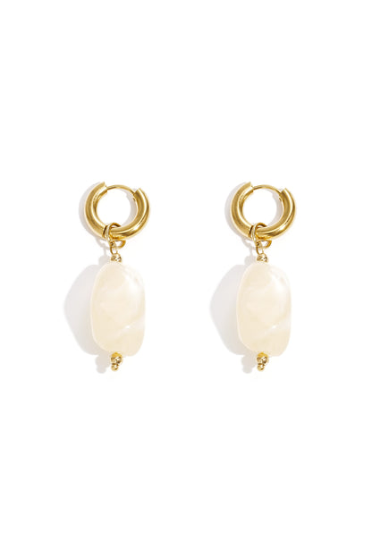 Gold hoop earrings with irregular mint green resin drop beads on white background