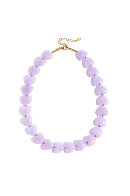 Lavender heart-shaped acrylic bead necklace with gold-tone accents on white background