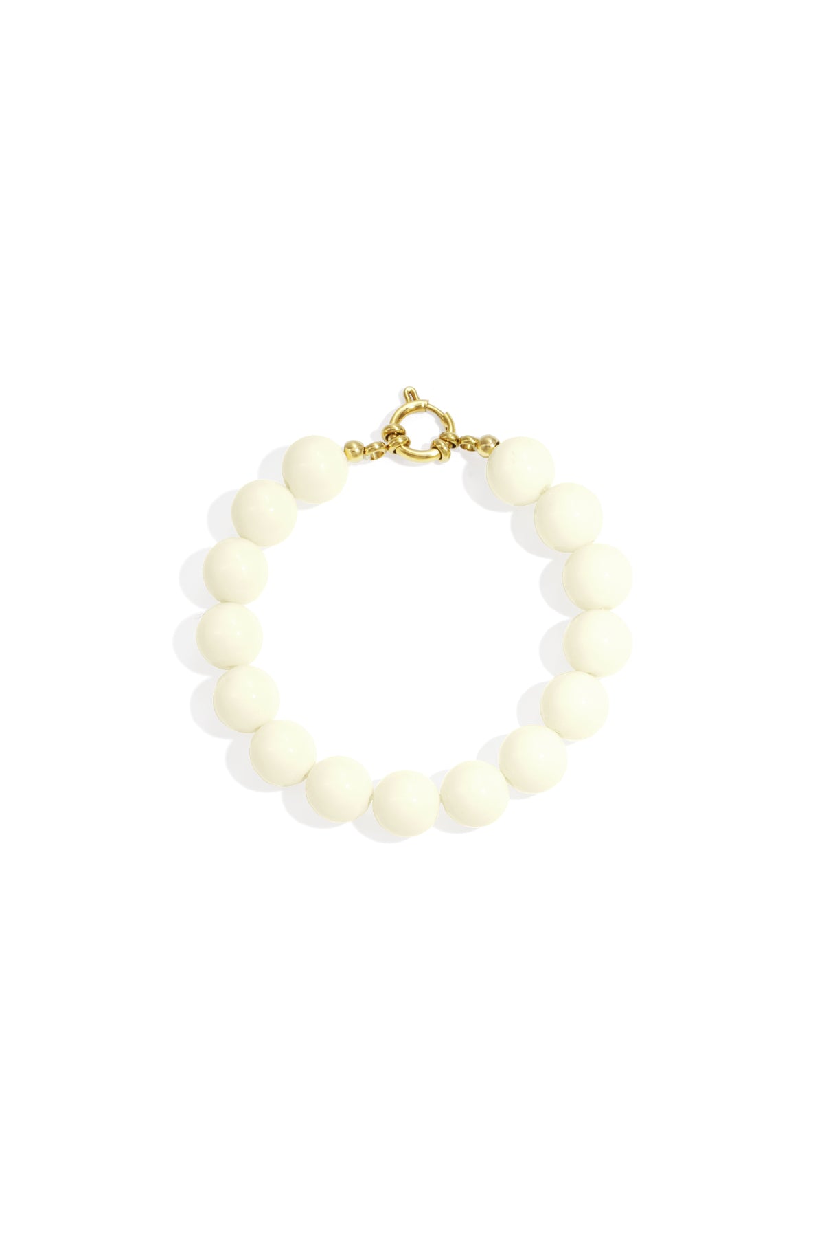 White resin bead bracelet with gold toggle clasp on white background