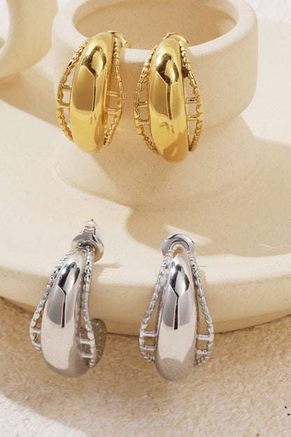 Chunky, glazed hoop earrings with a smooth center and beaded cage design, available in polished gold and silver tones.
