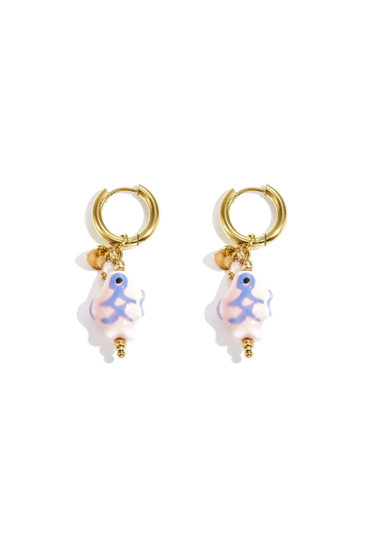 Pair of gold-tone hoop earrings with soft pastel pink ceramic fish charms featuring blue and green accents on white background