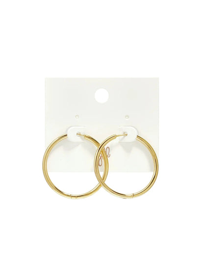 Gold hoop earrings mounted on a white display card.
