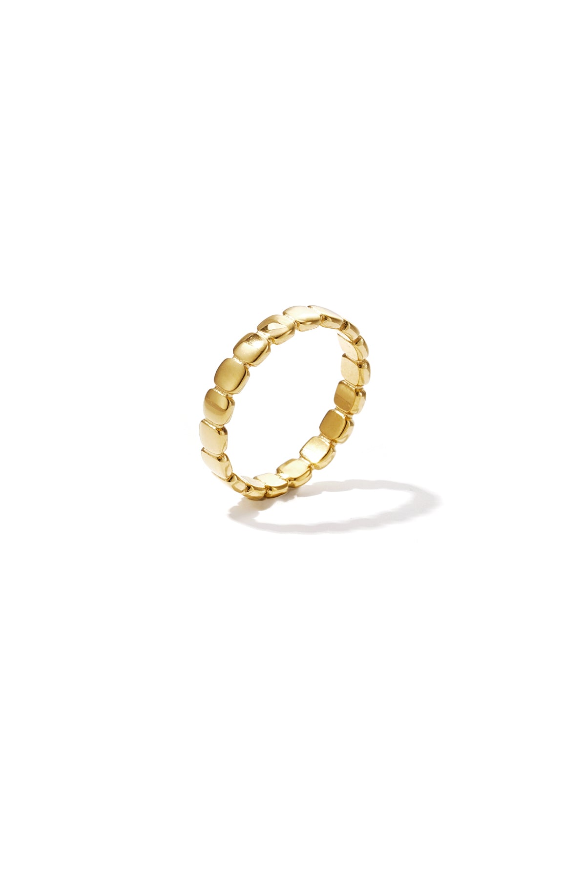 Close-up of a gold beaded ring with square-shaped links on white background