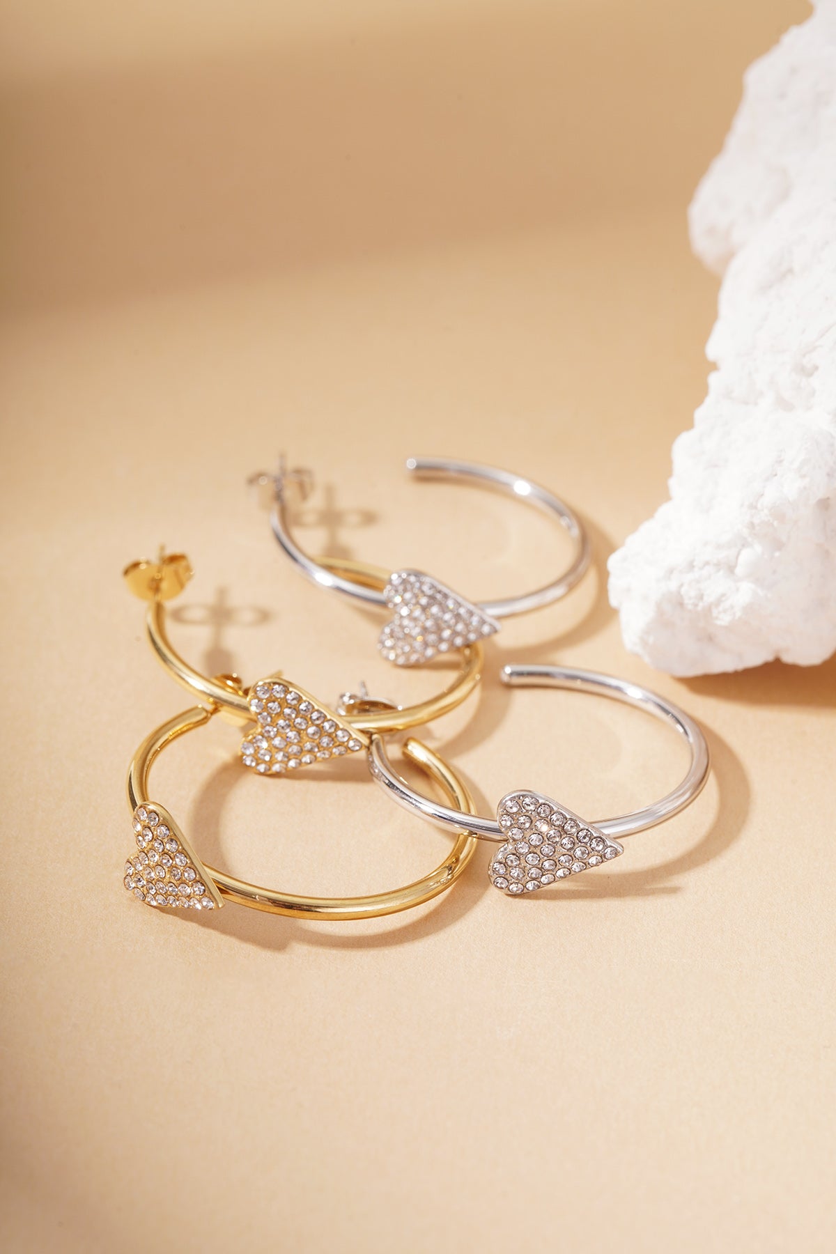 Coquette Sparkle Hoops: Gold and silver tone circular earrings featuring crystal-encrusted heart charms.